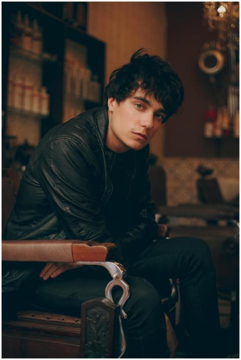 Fashionable young man posing in a stylish black ou