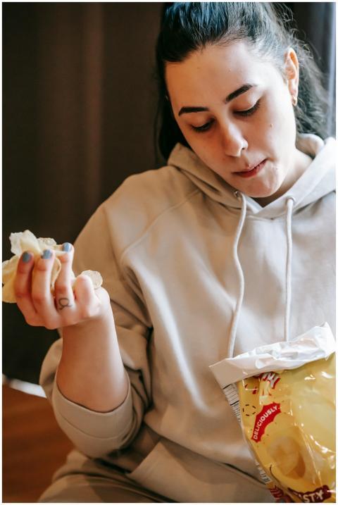 Casual young woman indulging in a bag of tasty pot