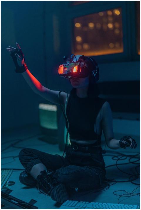A woman wearing VR headset and gloves explores a v