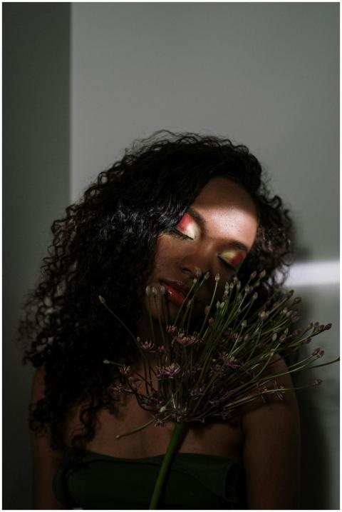 Artistic portrait of a woman with closed eyes hold