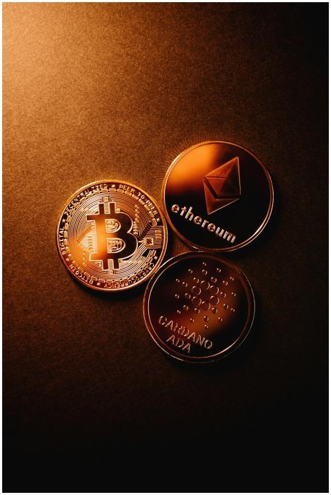 Close-up of Bitcoin, Ethereum, and Cardano coins a