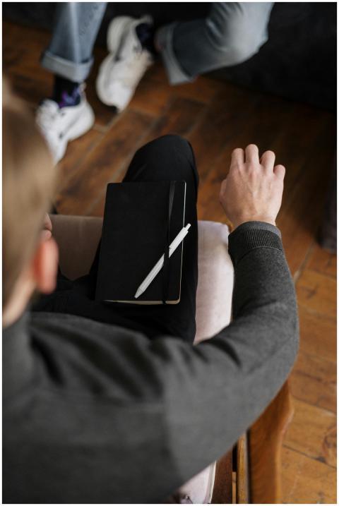 Overhead view of two people in a consultation, one