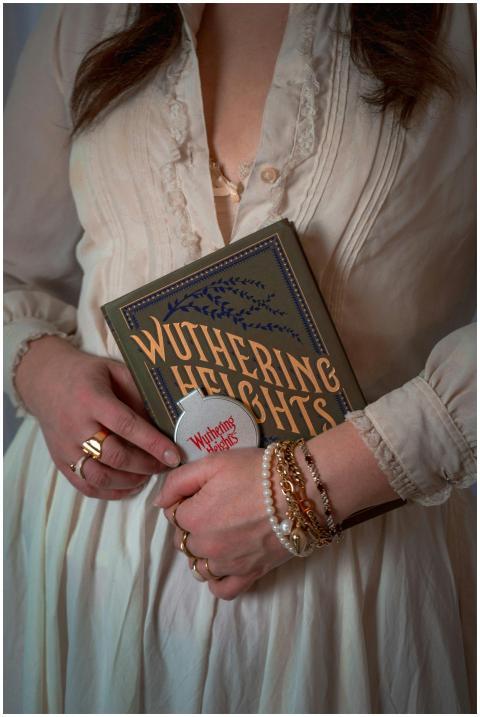 A woman in a vintage dress holding the classic boo