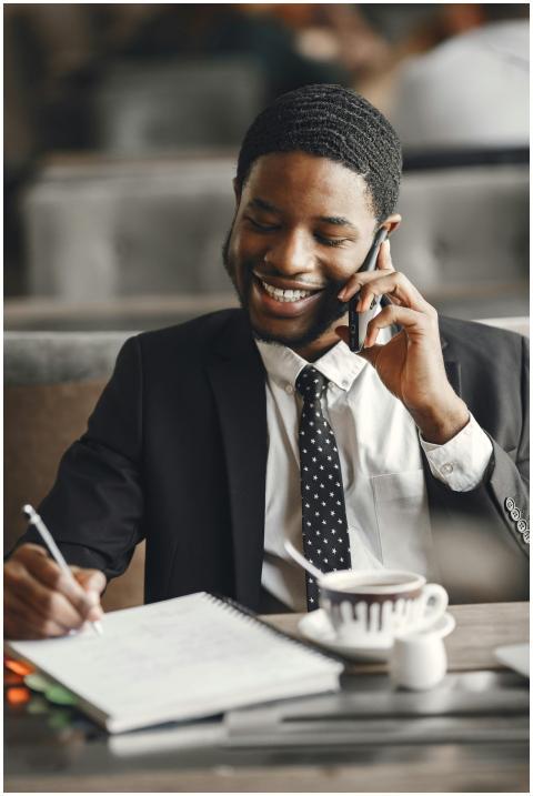 Smiling businessman talking on phone while taking