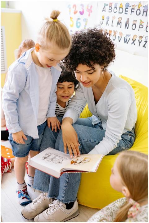 A teacher engaging young children with a storybook