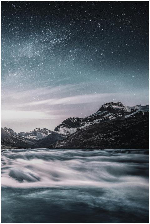 Majestic mountain river with star-studded night sk