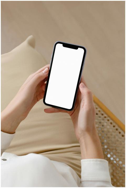 Woman holding smartphone with blank screen for moc