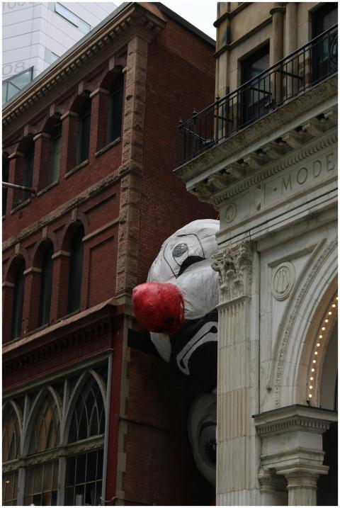 Creative street art of a giant panda between histo