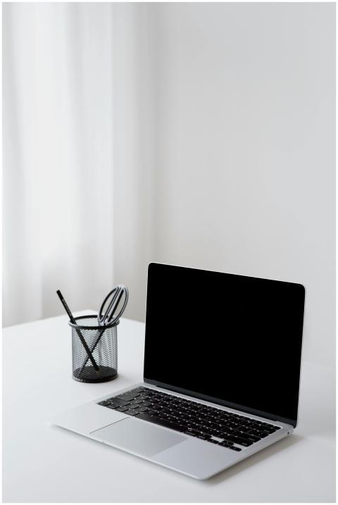 A minimalist office setup featuring an open laptop