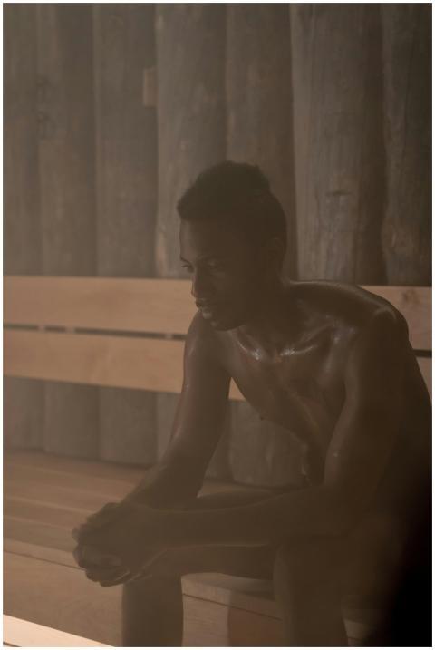 A man enjoying relaxation and selfcare in a dimly