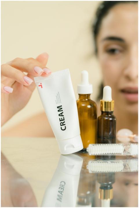 A woman selects skincare products including cream