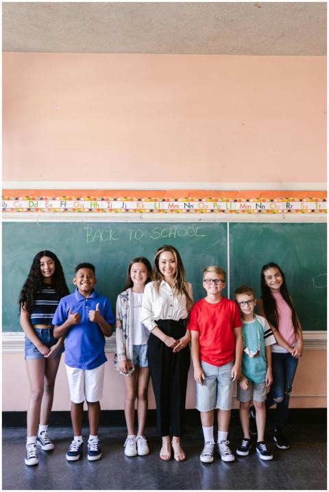 A diverse group of smiling students posing with th