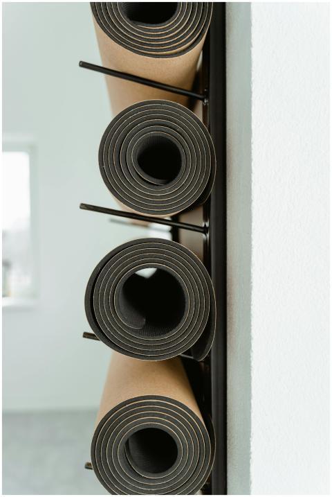An artistic view of stacked yoga mats in a modern