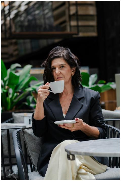 Stylish woman enjoying a coffee break in a contemp