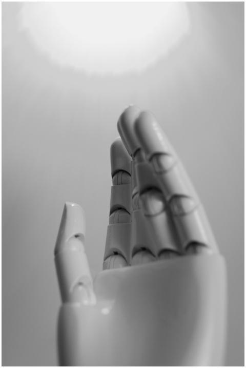 A monochrome close-up of an expressive robot hand