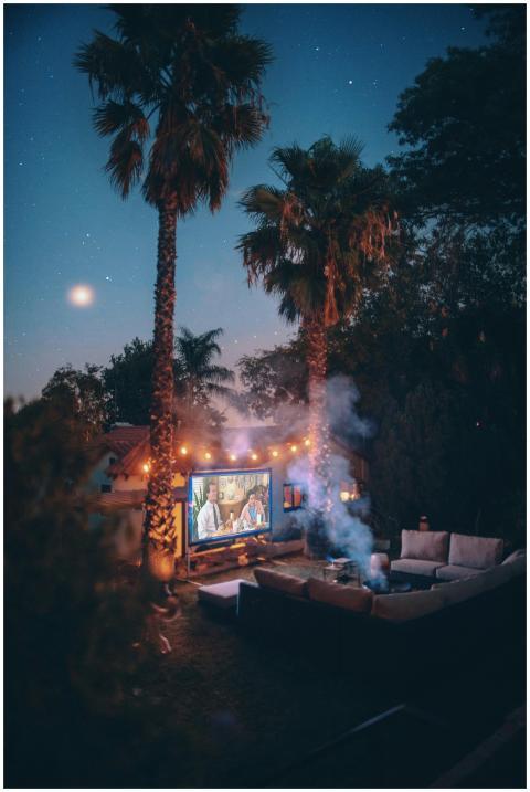 Relaxing outdoor movie night setup with projector
