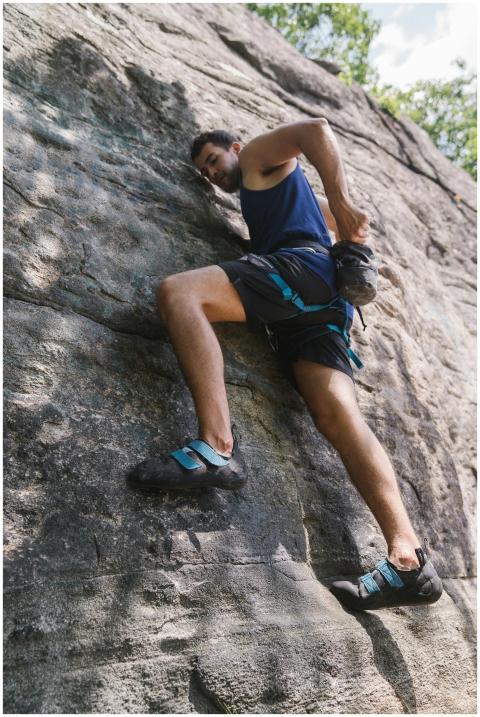 Man climbing a rocky surface outdoors showcasing s