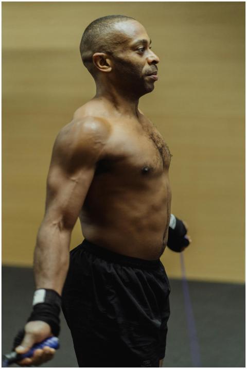 Fit man exercising with a jump rope indoors, showc