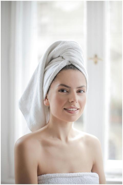 Young woman with towel wrapped around her head in