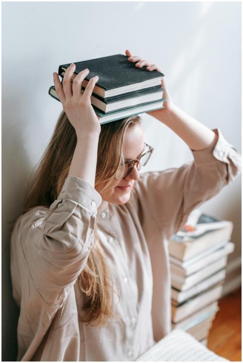 High angle of female in eyeglasses sitting near wa