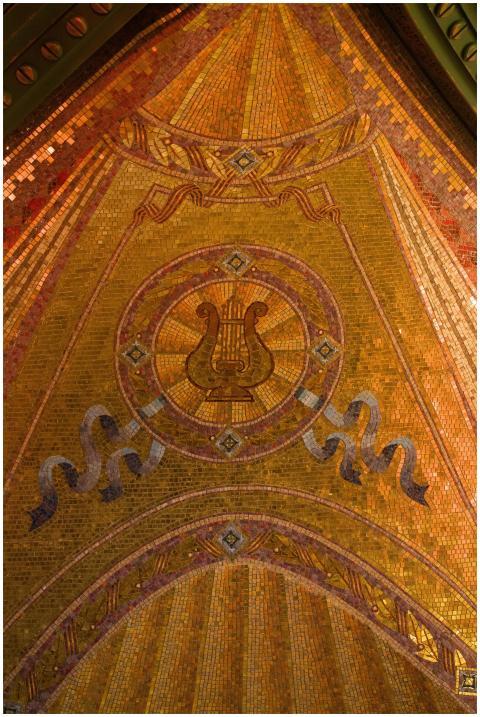 Intricate mosaic featuring a lyre motif in golden
