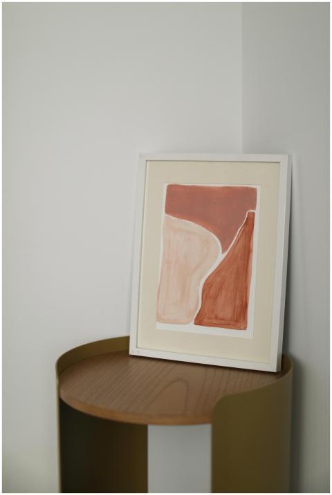 Simple minimalist abstract painting resting on a w