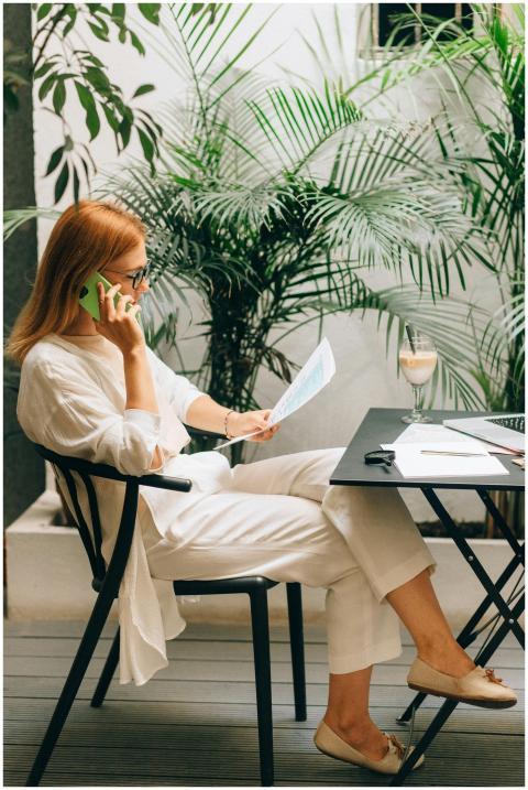 Professional woman working on documents and phone