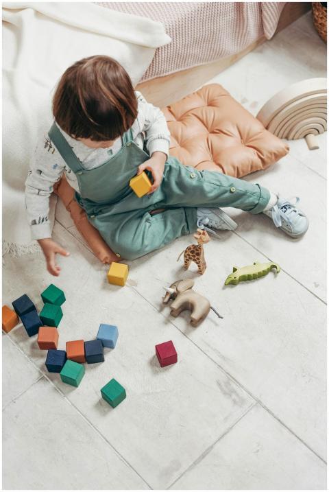 A young child engaged in play with colorful wooden