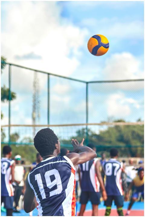 Athletes competing in a dynamic outdoor volleyball
