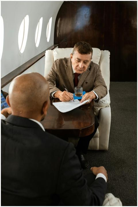 Two businessmen conduct a meeting inside a luxurio