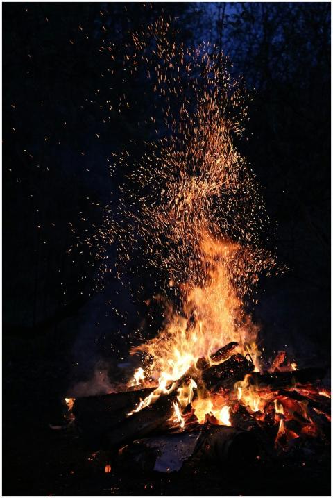 A blazing campfire illuminates the night, with spa