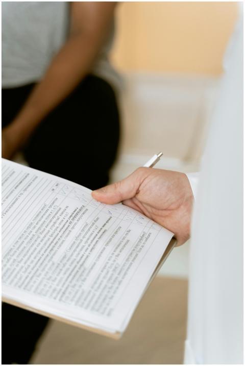 A healthcare professional reviewing a patient's me