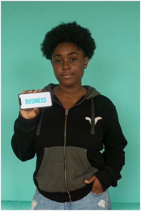 African American woman with afro hair holding a sm