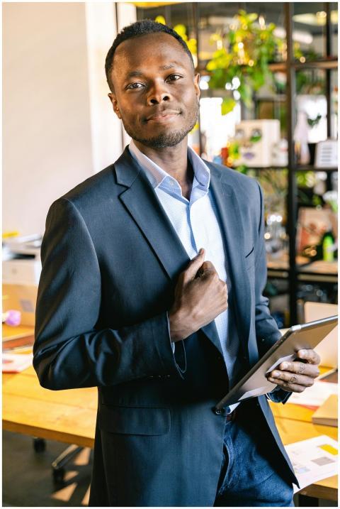 Smiling professional in a blue suit confidently ho