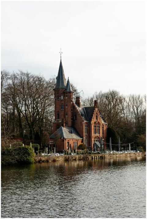 Historic brick house by a canal in Bruges, showcas