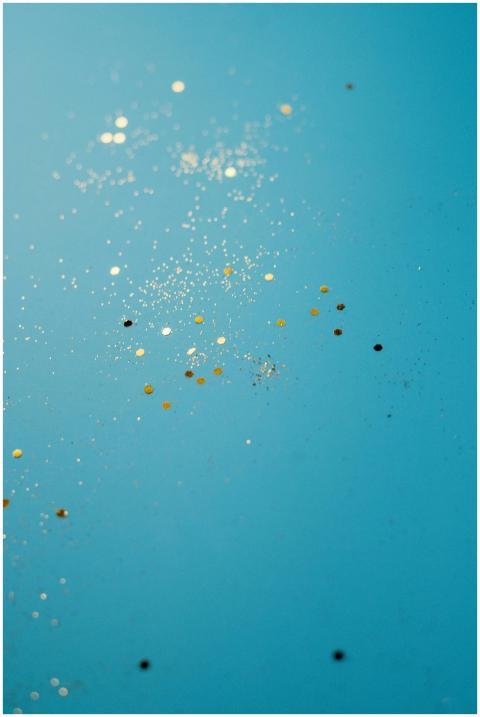 Enchanting vertical shot of gold glitter sparkles