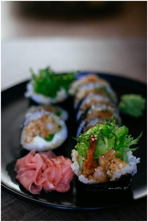 A close-up of sushi rolls with fresh ginger and wa