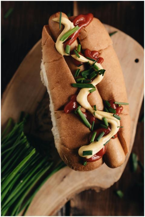 A delicious gourmet hot dog with mustard, ketchup,