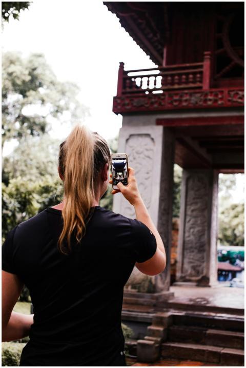 A woman captures an ancient structure with her sma