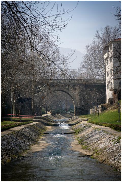 Peaceful scene of a river flowing under a historic