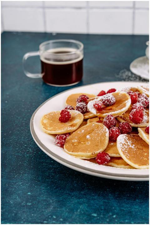 A scrumptious plate of pancakes with fresh raspber