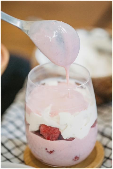 Creamy raspberry parfait in a glass with fresh fru