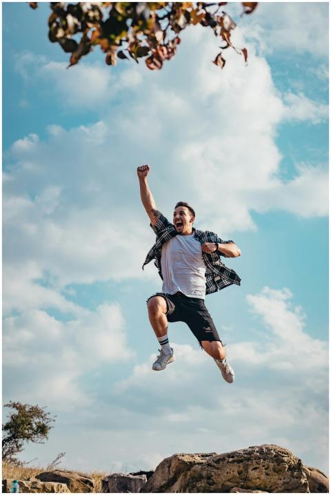 A vibrant image of a young man jumping with joy ou