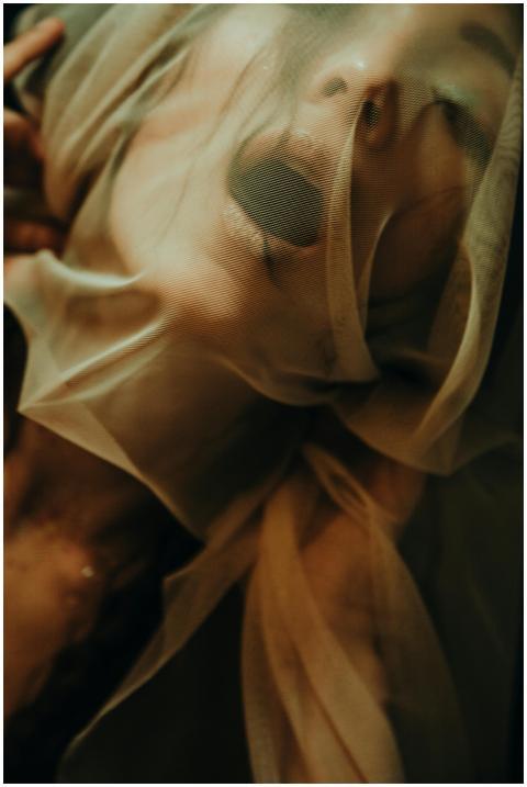 Conceptual portrait of a woman with sheer fabric,