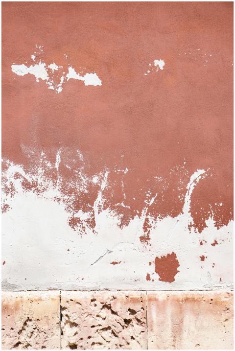 Close-up view of a weathered wall with peeling pai