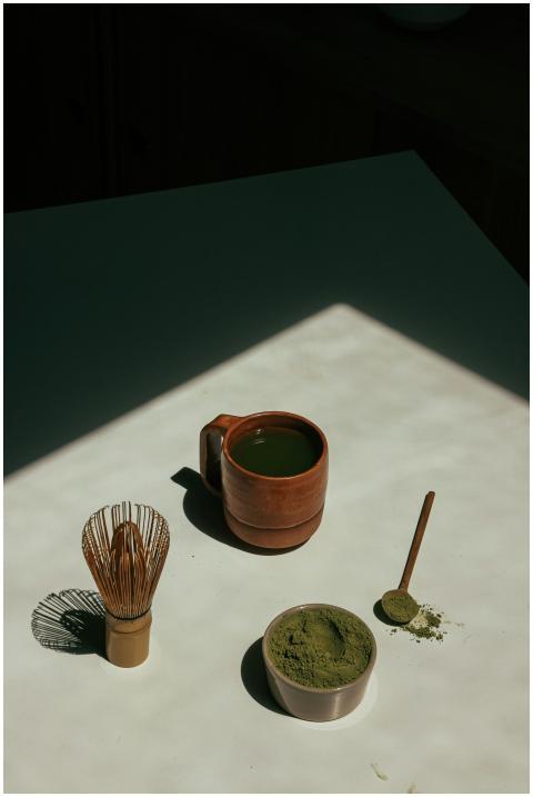 Serene still life of matcha tea with bamboo whisk