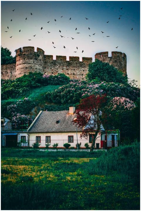 Charming cottage below a historic castle wall surr