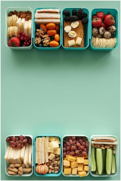 Top view of assorted healthy snack boxes with frui