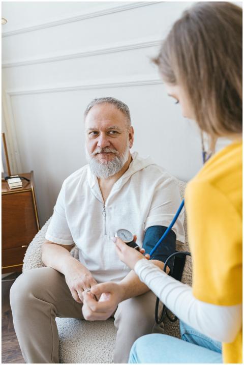 A healthcare worker takes the blood pressure of an