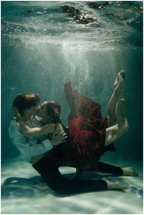 Artistic underwater photo of a couple embracing in